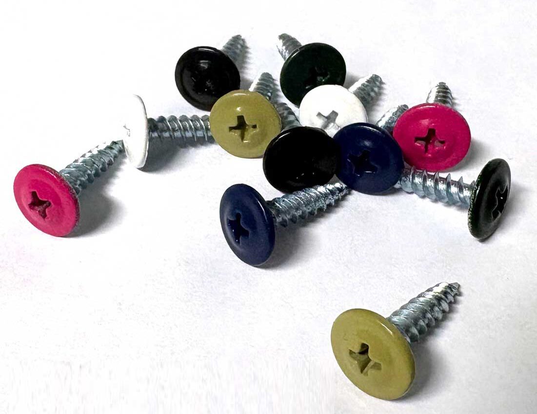 A selection of coloured powder coated PanelPro hoarding screws with coloured painted heads in various bright and vivid colours